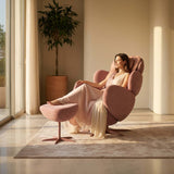 Elegant woman in a pink recliner massage chair with matching ottoman, enjoying comfort in a stylish living room.