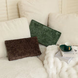 Nourest S1 wireless hot compress massage pillow on a cozy couch with a cup and magazines.