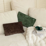 Nourest S1 wireless hot compress massage pillow on a cozy couch with a cup and magazines.