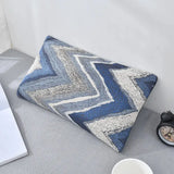 Nourest S1 wireless hot compress massage pillow with a blue and gray zigzag design on a desk.